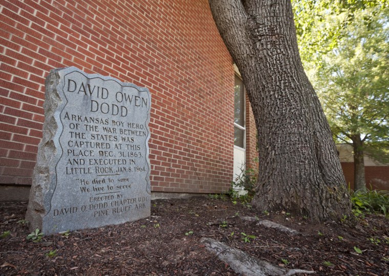 In this photo taken Sept. 18, 2012, a monument to teenage Confederate spy David O. Dodd, who was executed in 1864, is displayed in front of an elementary school named for him in Little Rock, Ark. Dodd is seen as a folk hero by many in his hope state. (AP Photo/Danny Johnston)