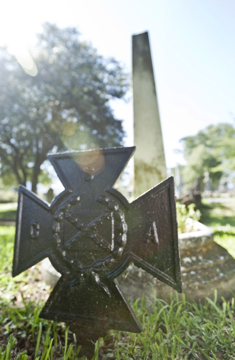 In this photo taken Sept. 18, 2012, a metal and a stone monument mark the grave of David Owen Dodd in Little Rock, Ark. The 17-year-old boy was executed in 1864 for being a Confederate spy. (AP Photo/Danny Johnston)