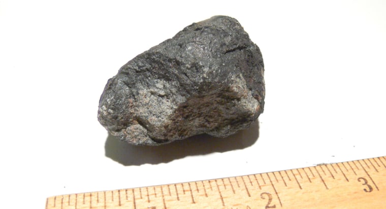 This rock, found in a backyard in Novato, Calif., was initially thought to be a meteorite deposited by an Oct. 17 meteor. Then meteorite expert Peter Jenniskens decided it was a "meteor-wrong" of earthly origin. Now he says closer inspection supports the meteorite claim.