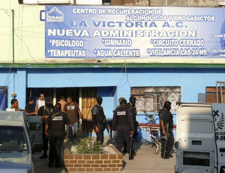 Image: Police stand outside a drug and alcohol rehabilitation centre in Torreon