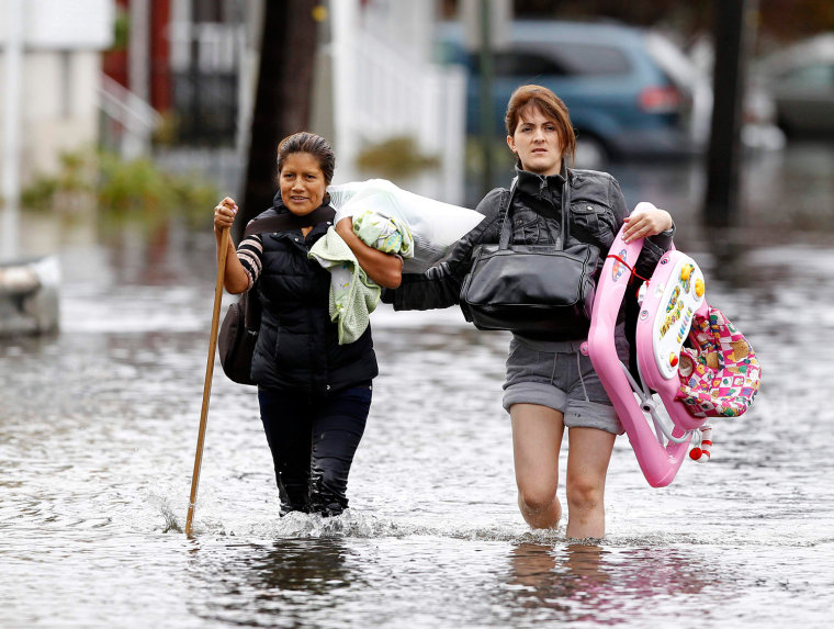 Image: Residents make their way through flood waters brought on by Hurricane Sandy in Little Ferry