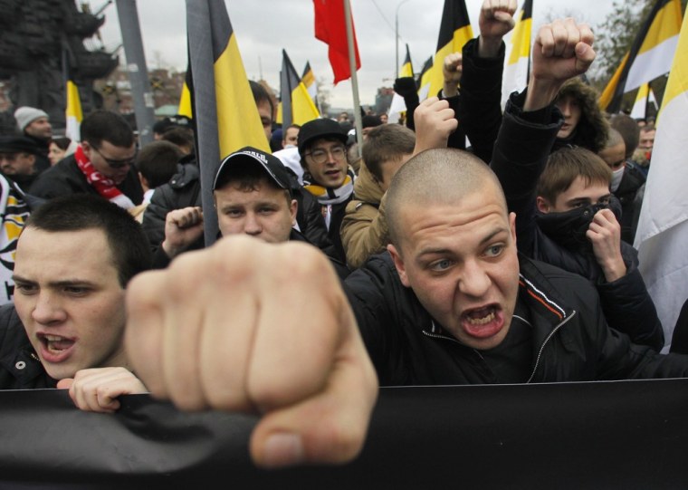 Image: Russian nationalists shout as they attend a \"Russian March\" demonstration on National Unity Day in Moscow