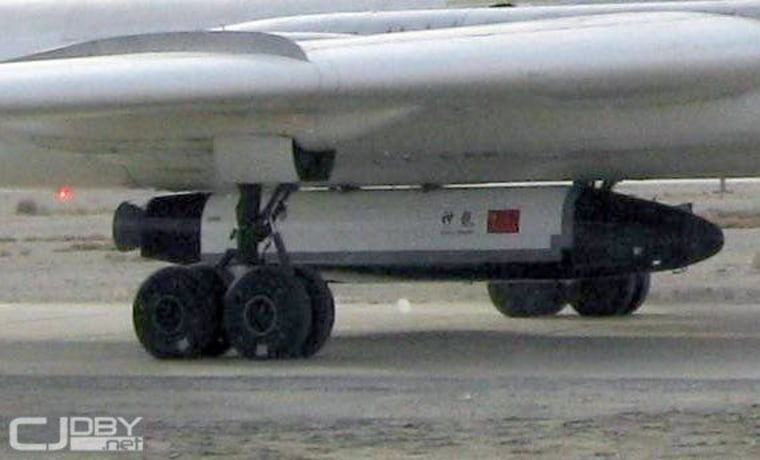 A close-up of China's robotic Shenlong space plane prototype tucked beneath a Chinese H-6 bomber for glide testing in December 2007.