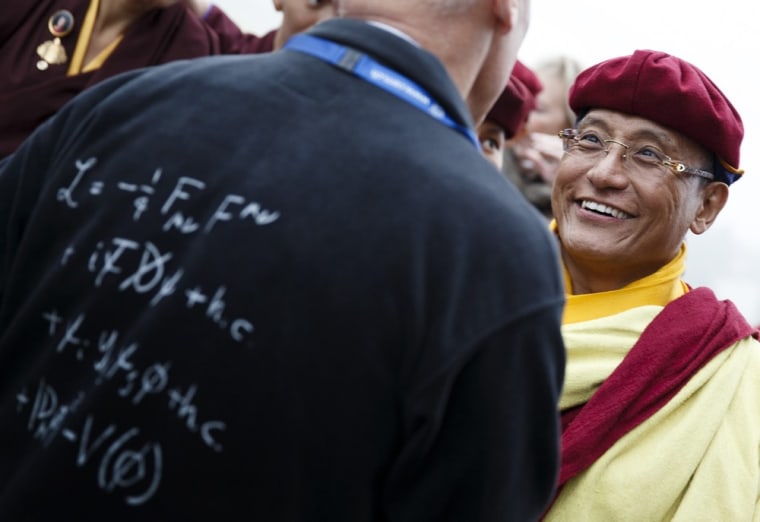 Image: The 12th Gyalwang Drukpa, Jigme Pema Wangchen, talks with a scientist after visiting the ATLAS experiment at the European Organization for Nuclear Research near Geneva