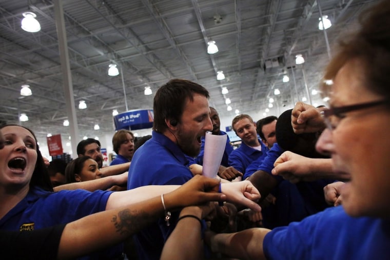 Image: Best Buy employees participate in a group huddle as they prepare to open the store in Naples, Florida