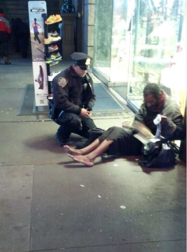 This photo, of Officer DePrimo helping a barefoot man on Times Square, was posted by Arizona tourist Jennifer Foster to her Facebook page.