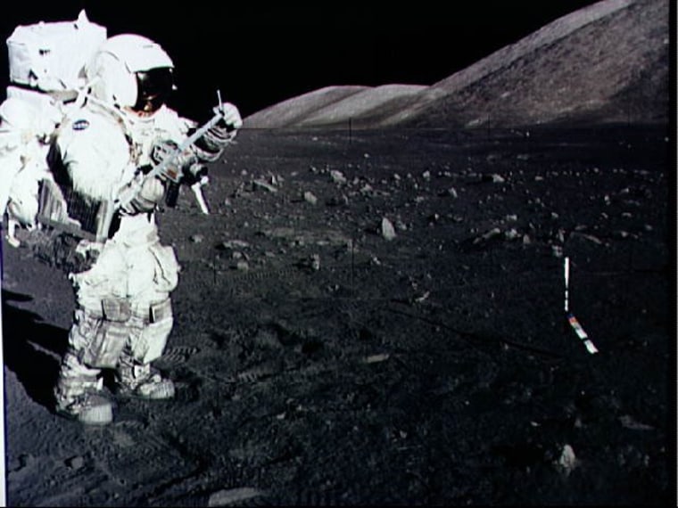 Astronaut Harrison Schmitt collects lunar rake samples during an Apollo 17 moonwalk in December 1973.