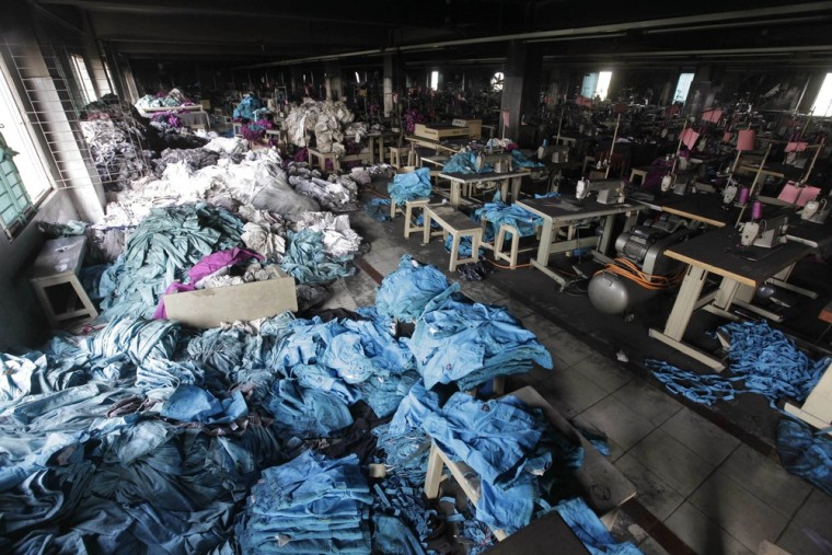 Image: Clothes and sewing machines are seen in the Tazreen Fashions garment factory, where 112 workers died in a fire, in Savar