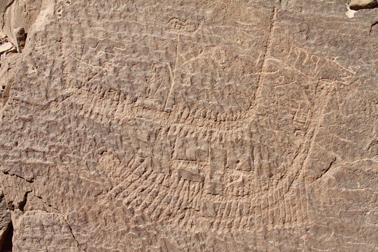 Look closely — standing on the top of this boat is a crowned figure who may represent Narmer, the first pharaoh to rule unified Egypt. Oarsmen propel the boat along.