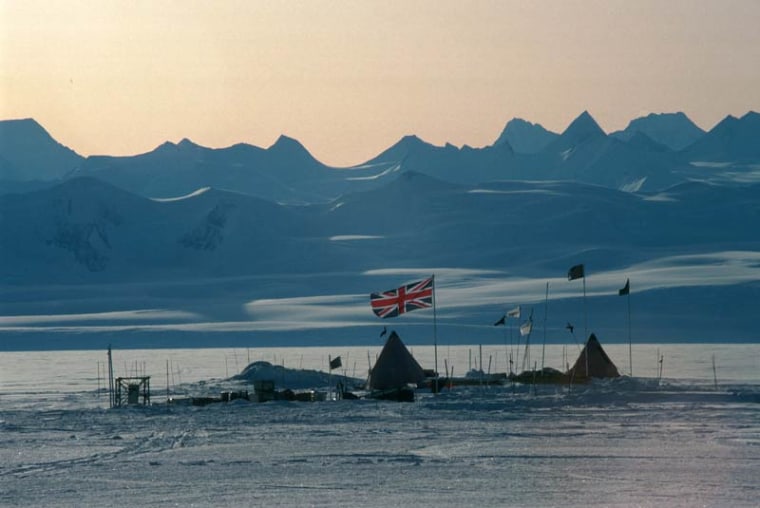The Union Jack flies over a field camp at Lake Ellsworth. In the background are the Ellsworth Mountains, the highest range in Antarctica.