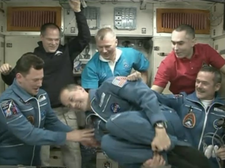 NASA astronaut Tom Marshburn does a flip in zero-g