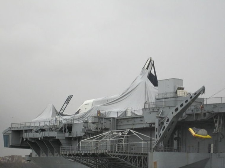 The space shuttle Enterprise is seen after Hurricane Sandy at the Intrepid Sea, Air and Space Museum in New York on Tuesday. Photo shows the shuttle's protective shelter has collapsed and the orbiter has incurred some damage.