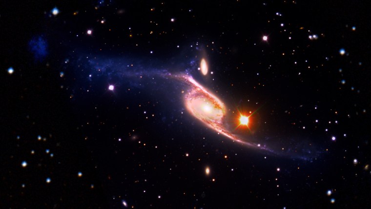 This composite of the spiral galaxy NGC 6872 combines visible light images from the European Southern Observatory's Very Large Telescope with far-ultraviolet data from NASA's GALEX and infrared data acquired by NASA's Spitzer Space Telescope. The spiral is 522,000 light-years across from armtip to armtip, which makes NGC 6872 about five times the size of the Milky Way.