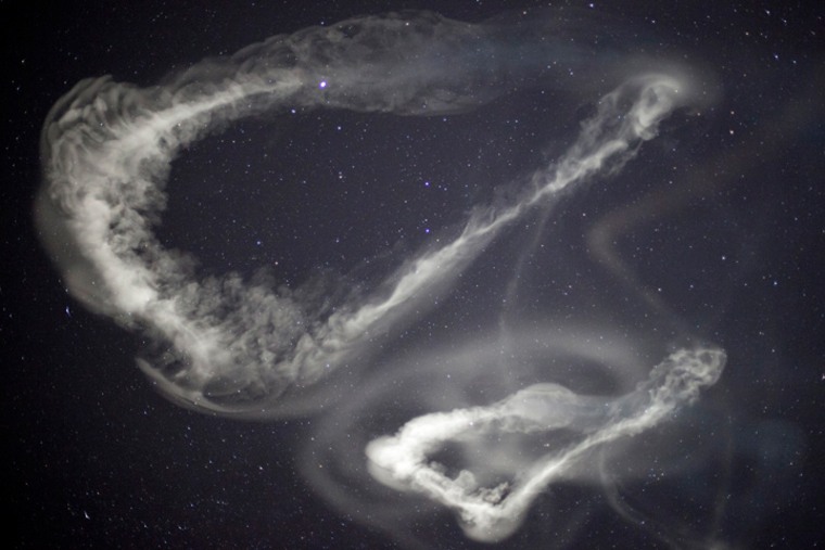 Two of the clouds left in the wake of the ATREX experiment shine on March 27, 2012. The rockets released trimethyl aluminum, a substance that burns spontaneously in the presence of oxygen.