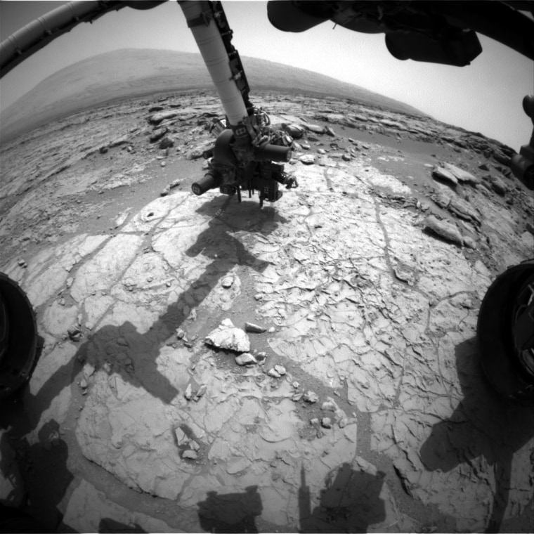 The percussion drill in the turret of tools at the end of the robotic arm of NASA's Mars rover Curiosity has been positioned in contact with the rock surface in this image from the rover's front Hazard-Avoidance Camera (Hazcam). The drill was positioned for pre-load testing, and the Hazcam recorded this image during the 170th Martian day, or sol, of Curiosity's work on Mars Sunday.