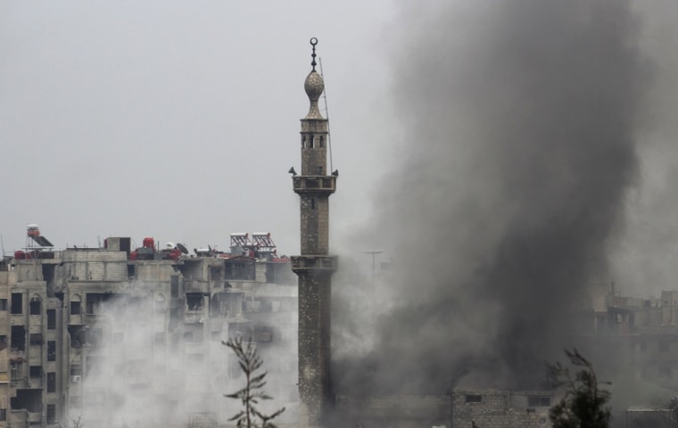 Image: Smoke rises from a mosque and another building during heavy fighting between the Free Syrian Army and President Bashar al-Assad's forces, in the Jobar area of Damascus