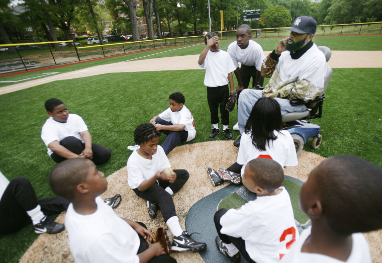 Coach Rodney Mason talks to the Newark Eagles Little League team after they suffered an emotional loss against the Philly Stars at Weequahic Park on May 14, 2008.
