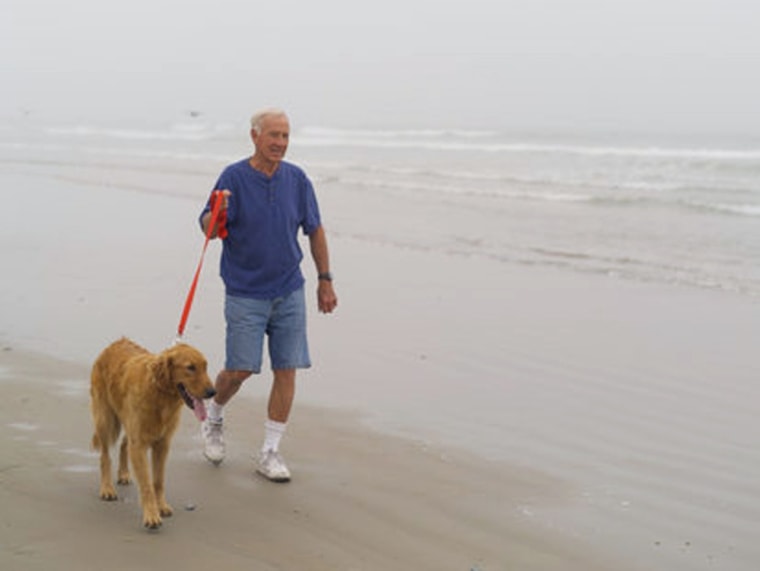 Image: Image: Man walking on the beach