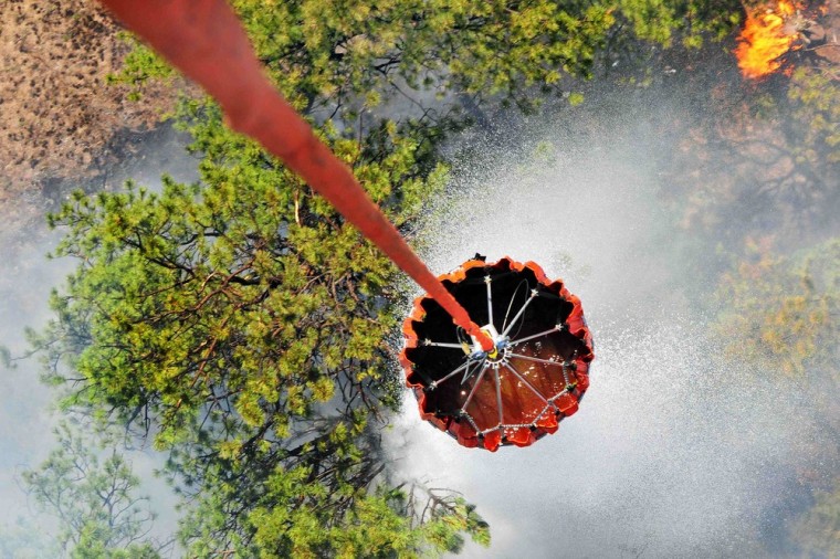 Image: Pilots and crew of the U.S. Army's 2nd General Support Aviation Battalion release water onto fires in Black Forest, Colorado