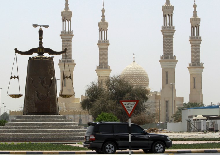 A justice symbol monument is seen in front of a mosque in Ras al Khaimah, United Arab Emirates.