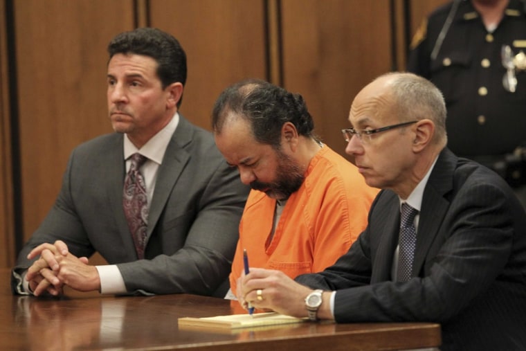 Image: Ariel Castro sits with his head down between his attorneys during his pre-trial hearing in Cleveland