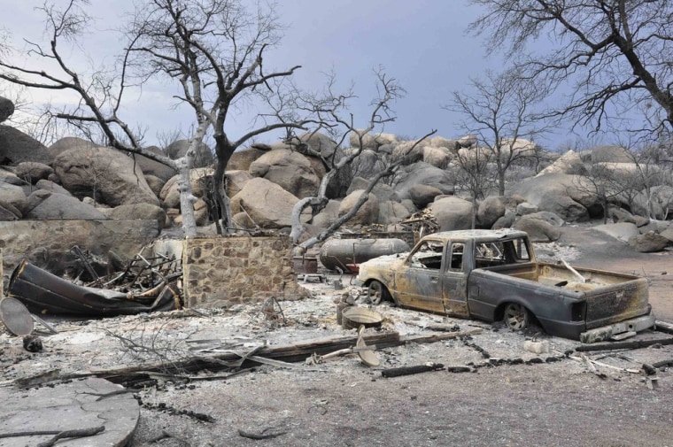 Image: A burned home is seen in an unidentified neighborhood in Yarnell, Arizona