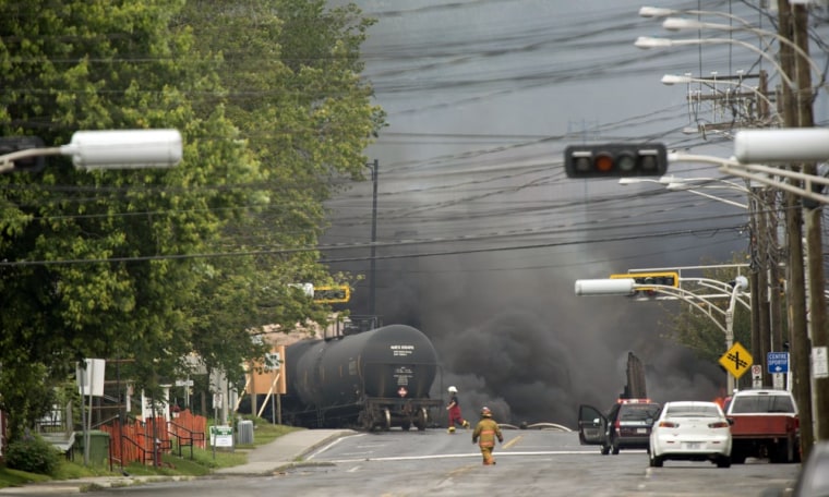 Image: Smoke rises from derailed train cars