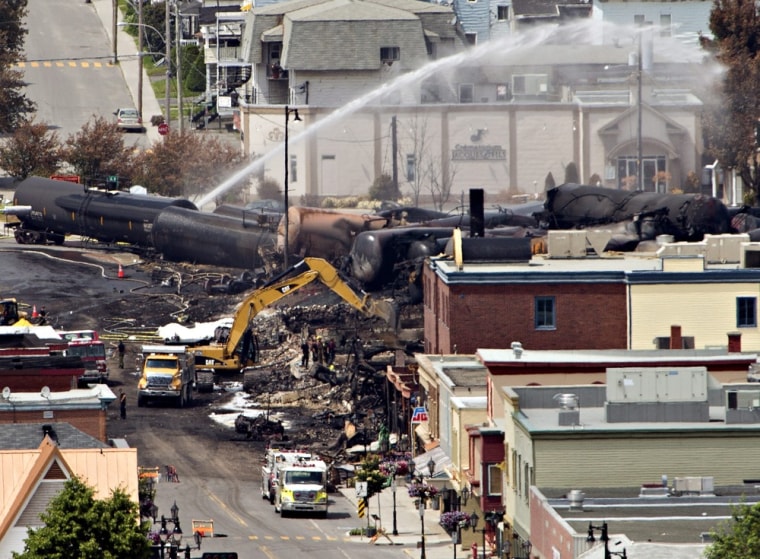 Image: Searchers dig through the rubble for victims of the inferno in Lac-Megantic, Quebec.