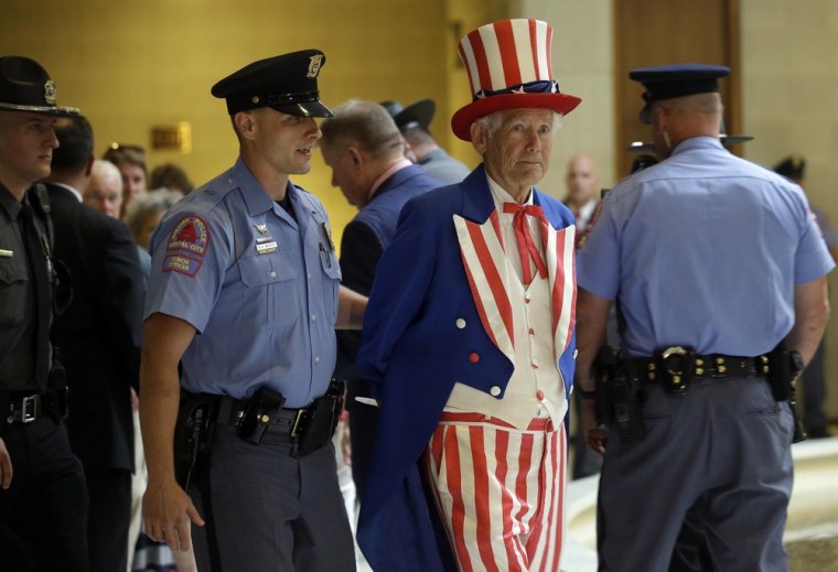 Image: A man dressed as Uncle Sam is arrested during \"Moral Monday\" demonstrations at the General Assembly in Raleigh.