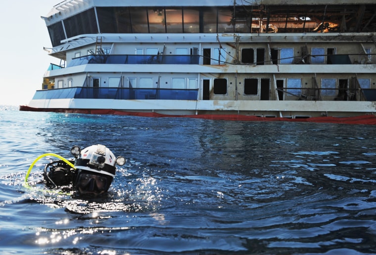 Image: A diver participates in a search operation Tuesday for missing bodies onboard the Costa Concordia.