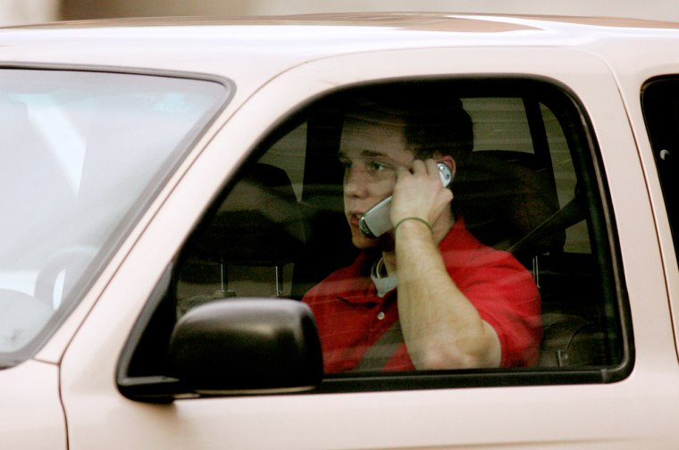 Image: Man talks on cell phone while driving