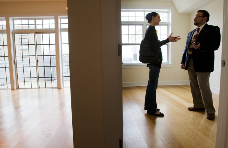 Image: Prospective home buyer talks with her real estate agent