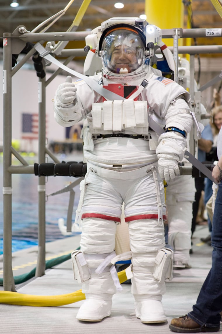 Dressed in a training version of his Extravehicular Mobility Unit spacesuit, Japan Aerospace Exploration Agency (JAXA) astronaut Satoshi Furukawa, Expedition 28/29 flight engineer, is about to be submerged in the waters of the Neutral Buoyancy Laboratory near NASA's Johnson Space Center as part of the training for his upcoming space station mission. 