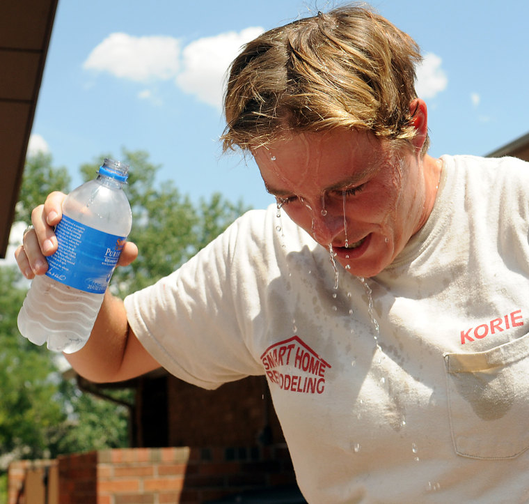 Image: Korie Holmes pours water on his head in 108 degree heat