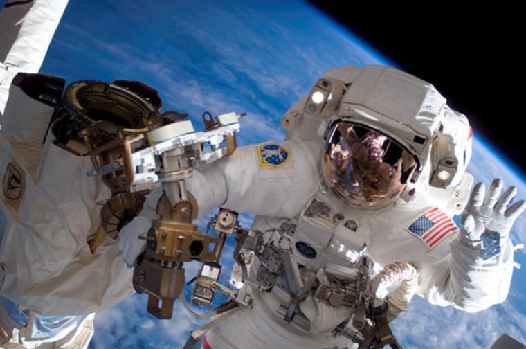 Astronaut Clay Anderson, Expedition 15 flight engineer, waves to the camera during a construction spacewalk on the International Space Station in July 2007.