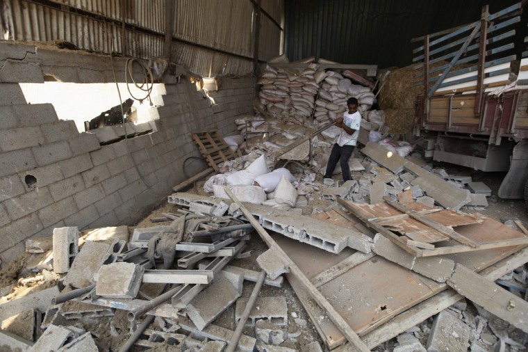 Image: A Palestinian surveys the damage the day after an Israeli air strike in the northern Gaza Strip