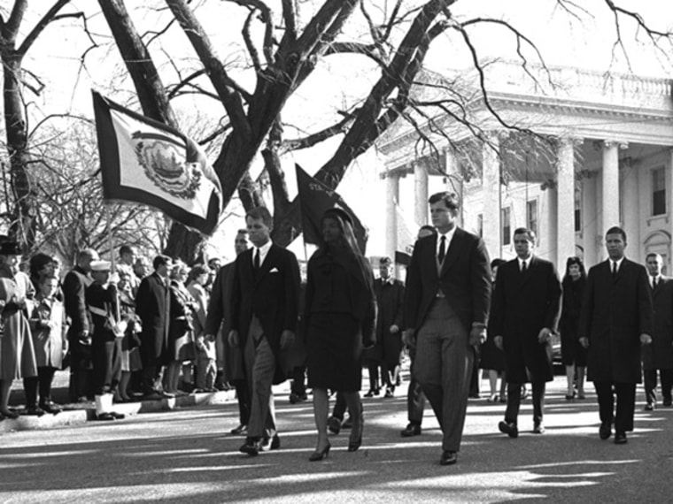 Widow Jacqueline Kennedy is flanked by her brothers-in-law in the procession carrying the coffin of slain President John F. Kennedy from the White House to St. Matthew's Roman Catholic Church in Washington, November 25, 1963.  At left is Attorney General Robert Kennedy, and at right is Sen. Edward Kennedy, D-MA.  (AP Photo/stf)