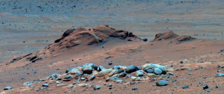 More than four years after Mars rover Spirit visited the Comanche outcrop in Gusev crater's Columbia Hills, scientists armed with a new instrument calibration have discovered the rocks are rich in long-sought carbonate minerals. Comanche (left) and Comanche Spur (right) appear reddish-brown in this false-color image from Spirit's Pancam.