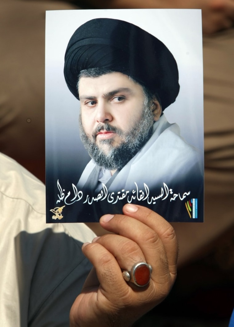 Image: An Iraqi supporter holds up a portrait of radical Shiite cleric Moqtada al-Sadr