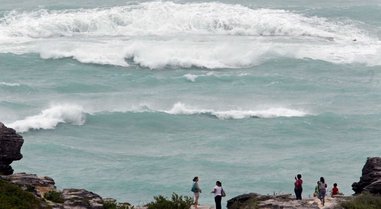 Image: People look out over the Atlantic Ocean