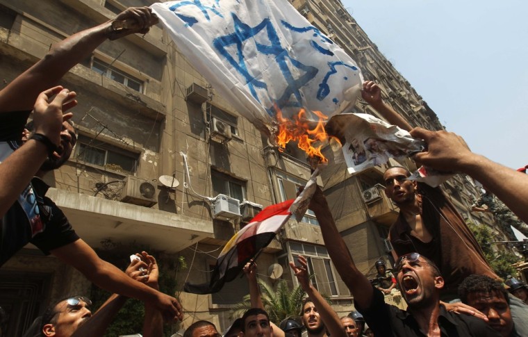 Image: Egyptian demonstrators burn an Israeli flag