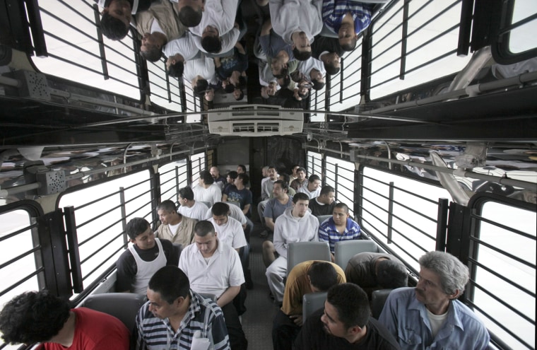 Shackled Mexican immigrants ride in a U.S. Immigration and Customs Enforcement bus for deportation in Harlingen, Texas.