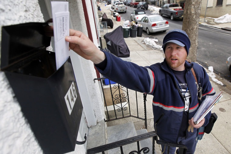 Image: Letter carrier Kevin Pownall delivers mail