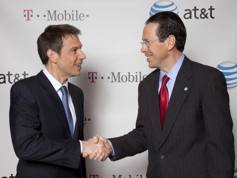 Image: Handout of AT&T Chairman and CEO Randall Stephenson and Deutsche Telekom Chairman and CEO Rene Obermann shake hands after announcing AT&T's $39 billion acquisition of T-Mobile USA in New York