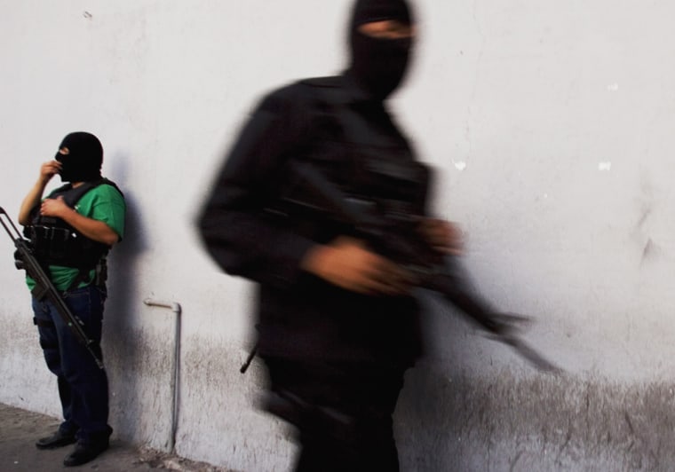 ** TO GO WITH MEXICO OBAMA DRUG WAR ** Hooded policemen stand guard at a street in Tijuana, Mexico, Monday, Sept. 29, 2008. Tijuana is among the cities hardest hit by violence as Mexico's drug cartels battle for lucrative smuggling routes past the border to supply illegal drug users in the United States. With US President-elect Barack Obama taking charge in Washington, Latin American nations are doing all they can to keep the U.S. focused on the region wide battle against drugs, fearing the issue will be caught up in a debate on human rights violations and corruption, or take a backseat to the many other problems demanding the new U.S. leader's immediate attention. (AP Photo/Guillermo Arias)