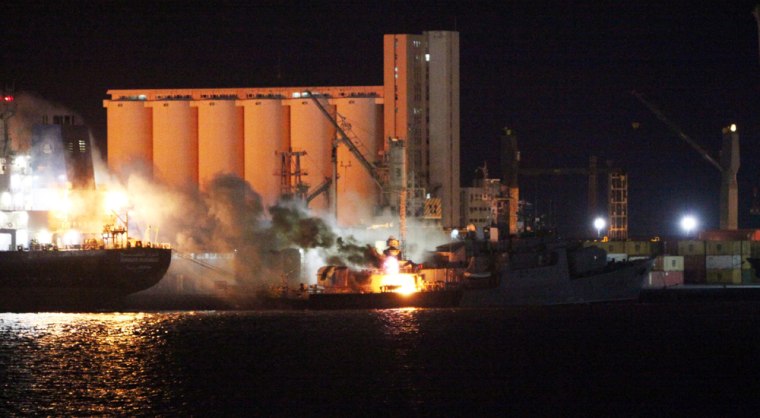 Image: Smoke rises from a fire on a boat on May 19, 2011 in Tripoli after NATO air strikes targeted the port of the Libyan capital.
