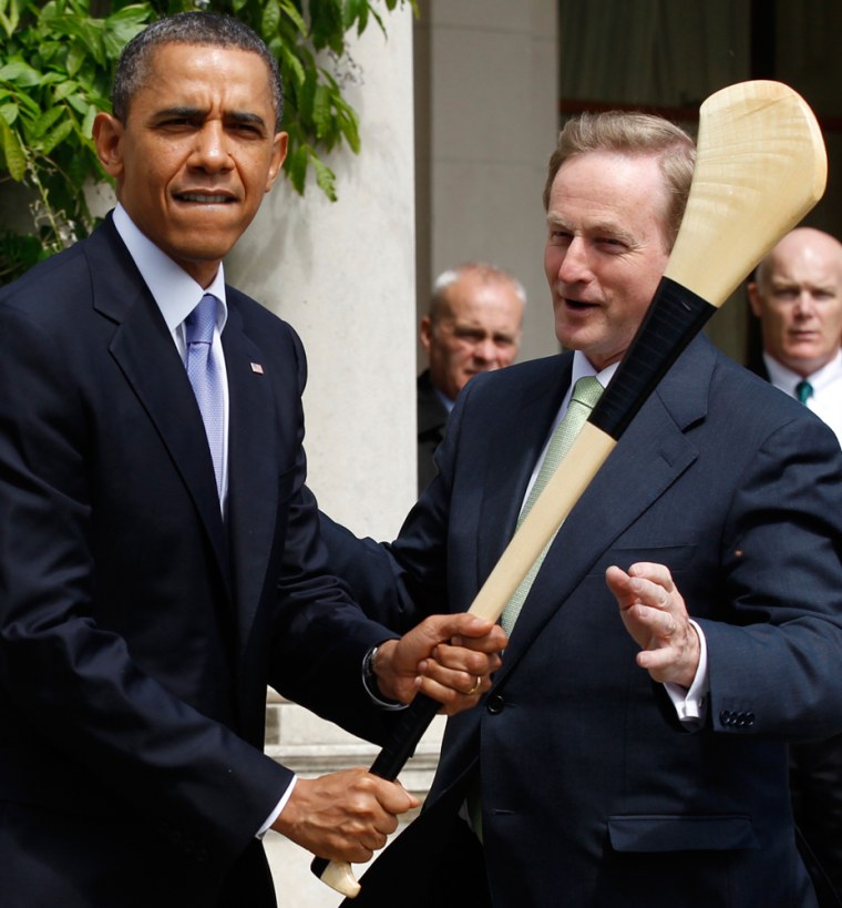 Image: U.S. President Barack Obama jokingly swings a hurling stick given to him by Taoiseach Enda Kenny during his visit to Farmleigh House in Dublin
