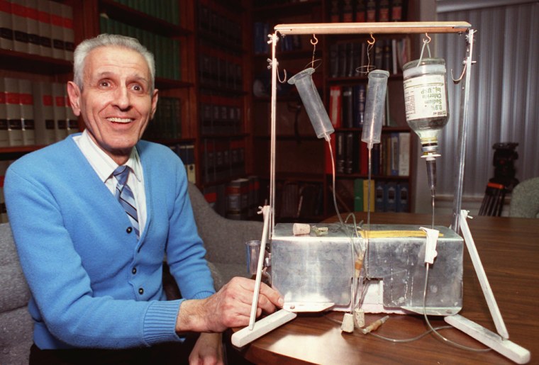 Dr. Jack Kevorkian poses with his \"suicide machine\" in Michigan, in 1991.