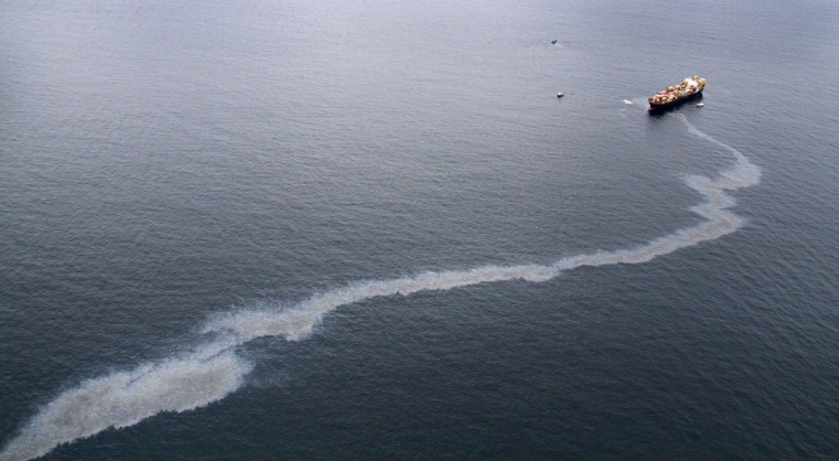 Image: An oil slick is seen coming from the grounded vessel Rena in Tauranga, New Zealand.