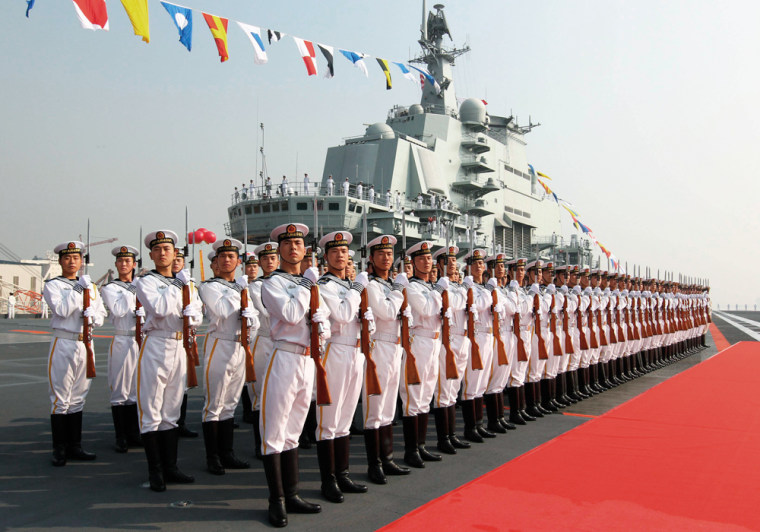 Image: Naval honour guards stand at attention in front of China's aircraft carrier \"Liaoning\"